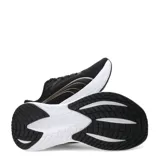 Championes de running Puma Max Stride Lite para mujer, color negro con detalles dorados en los laterales y entresuela alta de color blanco.
