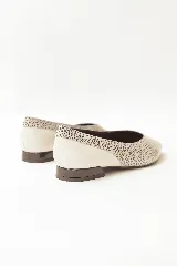 Chatitas de cuero con diseño combinado, presentando un cuerpo con estampado de puntos y puntera lisa en color blanco. Cuenta con punta fina y un taco bajo cuadrado en color oscuro.