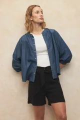 Bermuda negra de lino con tiro alto, lazo en la cintura y cuatro bolsillos grandes.