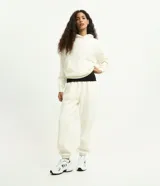 Pantalón jogger de mujer confeccionado en tejido fleece de algodón y poliéster. Presenta un corte holgado con cintura elástica y puños ajustados en el bajo.