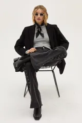 Bota de caña corta color negro, confeccionada en cuero, con punta cuadrada y taco bloque.