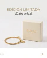 Pulsera elástica de acero dorado compuesta por pequeñas esferas, con un dije en forma de corazón y una placa rectangular con la inscripción 'Good Luck'.