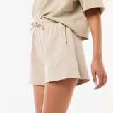 Short de felpa beige de corte holgado, con cintura elástica ajustable mediante cordón y bolsillos laterales.