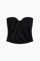 Top strapless negro de punto interlock con ajuste ceñido, escote corazón y diseño drapeado con frunces.