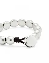 Pulsera con cuentas peque
nas de aleaci
f3n de metales ba
f1adas en plata de ley, con cierre de cuero marr3n.
