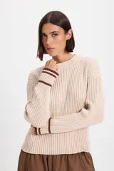 Sweater de punto acanalado con cuello redondo, manga larga con detalle de rayas en contraste en los puños y abertura para el pulgar.