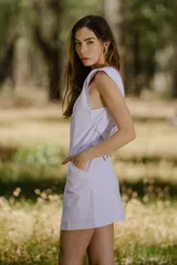 Vestido corto blanco con solapas tipo sastre, sin mangas y con bolsillos laterales.