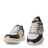Championes urbanos Umbro modelo Fade, con diseño multicolor que combina paneles en beige, azul marino, celeste y detalles en color mostaza. Presentan suela gruesa de plataforma y el logo de la marca en el lateral.