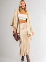 Ruana color beige de tejido liviano con destellos de mini lentejuelas.