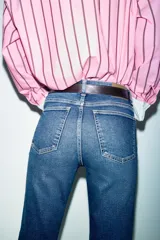 Jeans de tiro alto con corte mini flare y largo tobillero. Presentan diseño de cinco bolsillos, pernera estrecha con acabado evasé y cierre frontal con cremallera y botón.