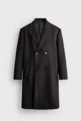 Abrigo relaxed fit de color negro, confeccionado en tejido con mezcla de lana. Cuenta con cuello con solapas de muesca, manga larga, bolsillos de vivo en la cadera, bolsillo interior, abertura central en el bajo de la espalda y cierre frontal de botonadura cruzada.