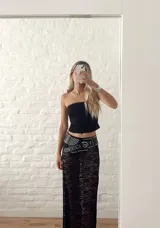 Pollera larga de encaje negro con abertura frontal y cintura elastizada.