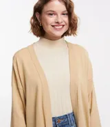 Cardigan abierto de punto fino color beige, con mangas largas y hombros caídos de la marca Blue Steel.