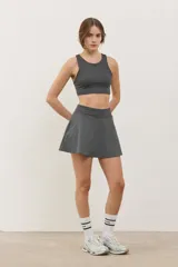 Pollera deportiva corta con calza incorporada, diseñada para actividades como pádel o tenis. Cuenta con cintura ancha de ajuste cómodo y bolsillo invertido en la calza para guardar pelotas. Confeccionada en tejido liviano y elastizado.