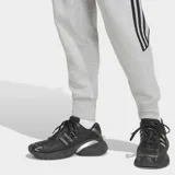 Pantalón de jogging Adidas Spacer Teamgeist 26 Cutline Cuffed de color gris melange, con ajuste relajado, puños en los tobillos, las icónicas tres tiras de la marca en negro en los laterales y el logo del trifolio bordado.