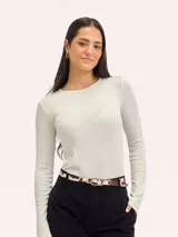 Camiseta de manga larga en tejido de punto acanalado, color blanco hueso, con cuello redondo y ajuste al cuerpo.