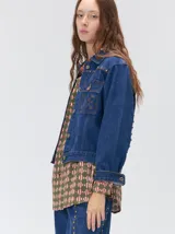 Campera denim crop de mezclilla oscura, con apliques metálicos en el pecho, bolsillos delanteros cruzados con detalles bordados y de parches.