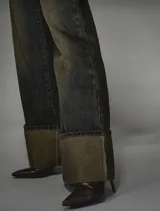Jean tiro alto, wide leg, de lavado oscuro con efecto desgastado y dobladillo ancho en el ruedo.
