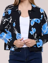 Camperita liviana de silueta entallada con estampado abstracto en tonos de azul y blanco, cuello camisero, cierre frontal con botones, bolsillos en el pecho con solapa y mangas largas.