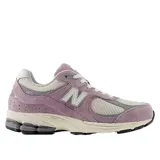 Championes urbanos New Balance modelo U2002Rrb, color lila con detalles en gris y blanco, confeccionados en gamuza y malla, con logo "N" característico en los laterales y entresuela ABZORB.
