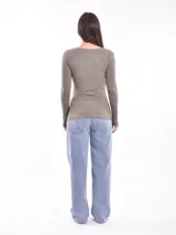 Remera de manga larga color rojo, con estampa frontal abstracta en color blanco que representa un rostro.