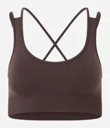Top deportivo Get Over color azul marino, confeccionado en poliamida sin costuras (seamless), con escote redondo, doble tirante cruzado en la espalda y diseño liso.