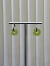 Aros tipo argolla con dije colgante en forma de dona de vidrio color verde lima.