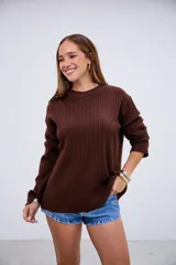 Sweater de punto acanalado color marrón chocolate, con cuello redondo y mangas largas con puños ajustados.