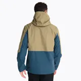 Campera impermeable tipo hardshell de la marca Merrell, con diseño bicolor en tonos arena y azul oscuro. Cuenta con capucha ajustable, cierre frontal y bolsillos en el pecho con cremalleras impermeables en color naranja vibrante, ventilación en axilas y puños ajustables.