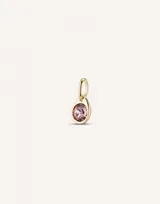 Charm de metal bañado en oro con cristal rosa facetado en forma circular.