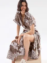 Vestido camisero midi color marrón con estampado de hojas y flores blancas, cuello camisero, mangas cortas con puños y cinturón de soga.