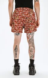 Short de baño de microfibra de secado rápido, con estampado de rosas rojas y figuras de mujeres en estilo pin-up. Incluye malla interna y un bolsillo trasero.