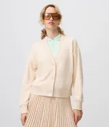 Cardigan de algodón color beige con escote en V, cierre frontal con botones y puños y cintura acanalados.