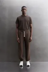 Pantalón jogger relaxed fit de Zara Athleticz confeccionado en tejido de algodón color marrón, con cintura elástica ajustable mediante cordón en contraste, bolsillos laterales y bajo con puño elástico.