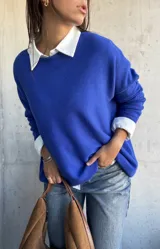 Sweater de punto color azul, de corte oversize, con cuello redondo y mangas largas.
