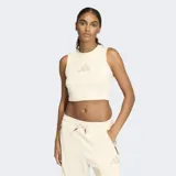 Musculosa deportiva Adidas línea Z.N.E. de corte ajustado, color beige claro, con cuello redondo y logo de la marca estampado en el pecho en tono a juego.