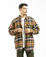 Sobrecamisa de franela con diseño de cuadros en tonos mostaza, verde, blanco y rojo. Presenta cuello clásico, cierre frontal con botones, dos bolsillos frontales con tapa y botón, y puños abotonados.