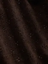 Buzo polera de punto con diseño calado pointelle, de corte holgado, cuello alto y mangas largas con puños acanalados.