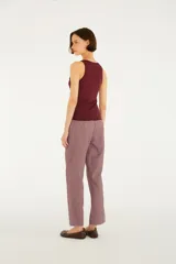 Pantalón de tiro medio y calce recto, confeccionado en tejido liviano con estampado cuadrillé en tonos rojo y blanco. Su diseño clásico y versátil incorpora bolsillos funcionales y cierre frontal.