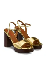 Sandalias de cuero charolado color peltre, con plataforma de madera y taco cuadrado.