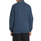 Campera deportiva Adidas Originals de la selección de Italia, color azul marino con cuello polo, cierre frontal completo, bolsillos laterales y las icónicas tres tiras blancas en las mangas. Presenta el logo del trébol de Adidas y el escudo de la selección italiana en el pecho.