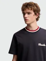 Remera de algodón color blanco con cuello redondo acanalado en tonos rojo, blanco y azul marino. Presenta el logo de la marca bordado en el pecho en color azul marino.
