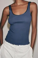 Musculosa de algodón color azul marino, de ajuste slim fit, con escote redondo y terminación ondulada en el bajo.