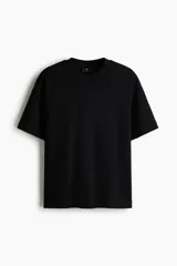 Remera de corte holgado en punto interlock de algodón, con cuello redondo acanalado, hombros caídos y bajo recto.
