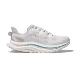 Championes Hoka modelo Kawana 2, color gris claro con detalles en azul y blanco. Presenta una suela con diseño moteado y logo de la marca en el lateral.