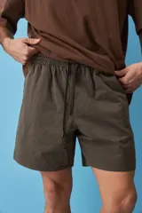 Short de gabardina color beige con calce relajado, cintura elástica con cordón ajustable y largo a mitad de muslo.