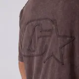 Remera de algodón con efecto acid wash en color marrón, de corte regular y mangas cortas, con sutil estampado en el pecho.