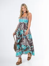 Vestido largo de algodón italiano con estampado floral en tonos azul, amarillo y blanco. Tiene escote cuadrado, corte imperio y elástico en la espalda.