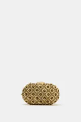 Bolso de mano tipo clutch rígido, revestido con abalorios y lentejuelas doradas formando un patrón de flores en relieve. Cuenta con cierre de clip metálico superior y estructura ovalada.