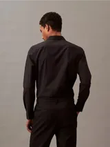 Camisa negra de corte slim fit, con cuello clásico y mangas largas.
